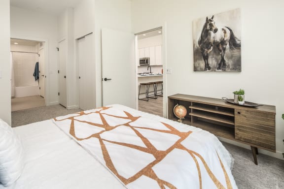 a bedroom with a bed and a painting of a horse