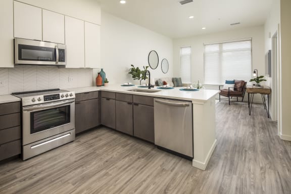 a kitchen with stainless steel appliances and a white counter top