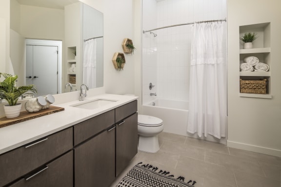 a bathroom with a sink and a toilet and a shower
