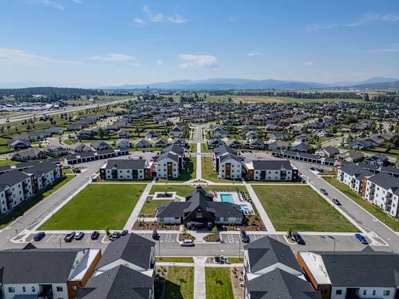 A bird&#x27;s eye view of a residential area with houses and a park.