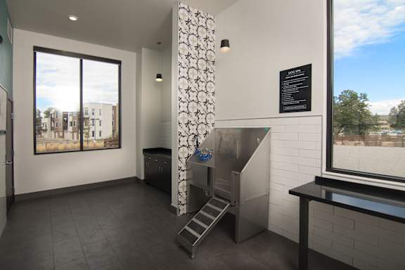 a small room with a stove and a window at Cycle Apartments, Fort Collins, Colorado