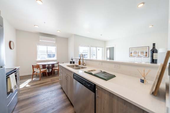 A modern kitchen with a large island and stainless steel appliances.