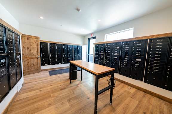 A room with a table and a list of names on the wall. at Silverbrook Apartments, Kalispell, Montana