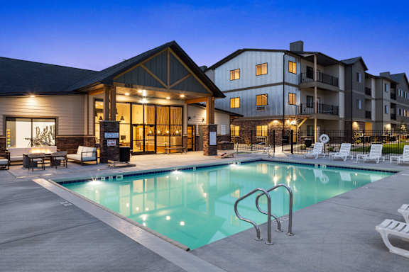 a swimming pool at night in front of a building at The Expo, Billings, MT, 59106