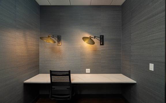 a desk in a room with two lights and a chair at Sylvan Uptown, Colorado, 80203