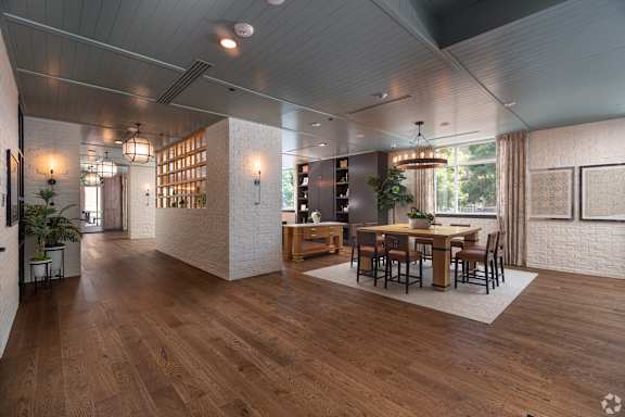 a tasting room with wooden floors and a table and chairs at Sylvan Uptown, Colorado, 80203