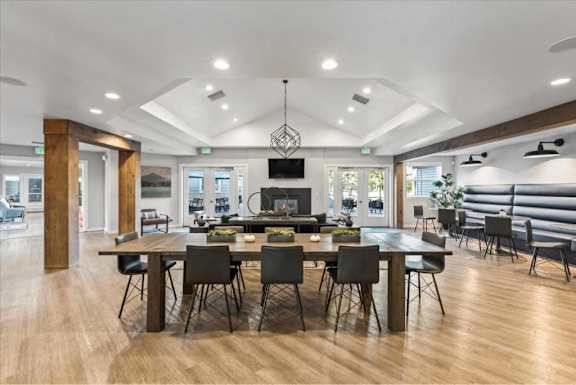 Spacious community room with coffered ceiling and fireplace at Edgewater Apartments, Boise
