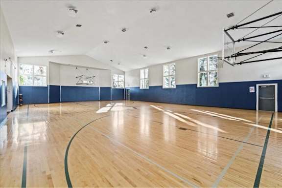 Basketball gym with court markings and hoop at Edgewater Apartments, Boise