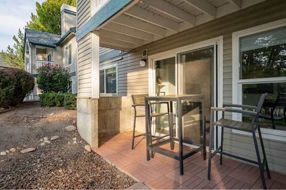 Private patio with outdoor dining furniture at Edgewater Apartments, Boise, Idaho