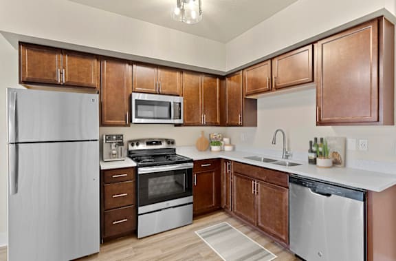A kitchen with wooden cabinets and stainless steel appliances.
