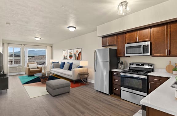 A modern kitchen with a refrigerator, oven, and microwave.