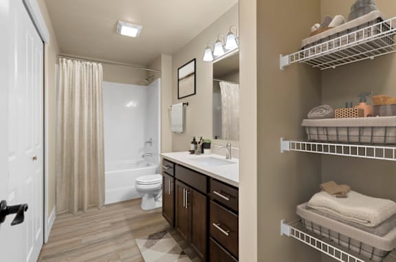 A bathroom with a toilet, sink, and shower.