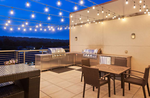 A patio with a table and chairs is set up for an outdoor meal.