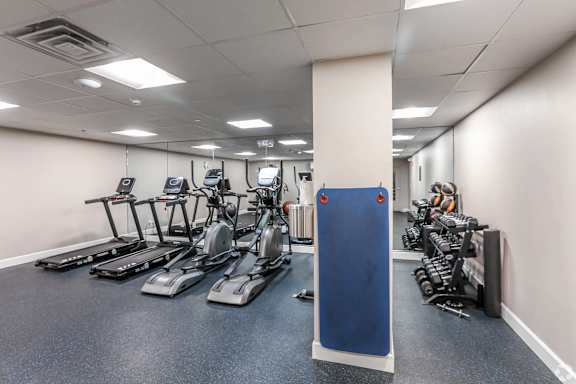 A gym with treadmills, exercise bikes, and weights at 7 Cameron Apartments, Cambridge