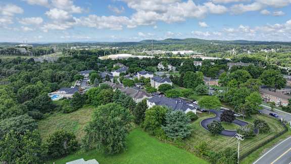 A bird's eye view of a residential area with houses and greenery.