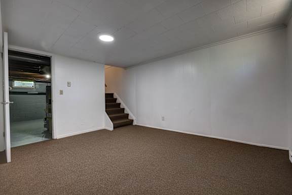 A room with a staircase leading to another room.