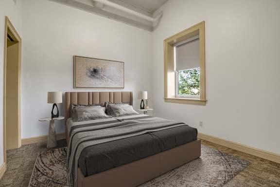 an empty bedroom with a bed and a window