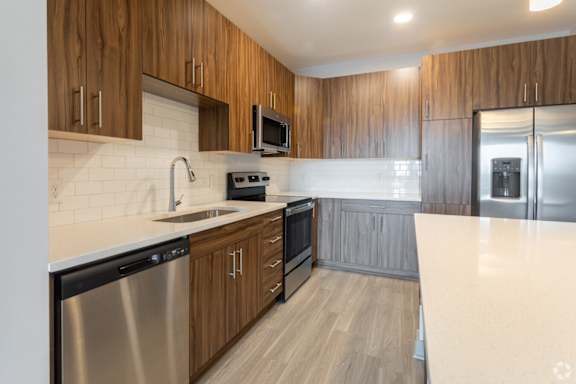 a kitchen with wooden cabinets and a white counter top