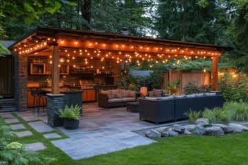 A cozy outdoor patio area with a bar and seating area.