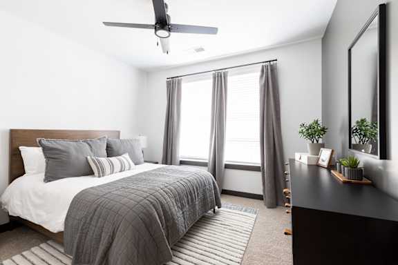 a bedroom with a large bed and a large window