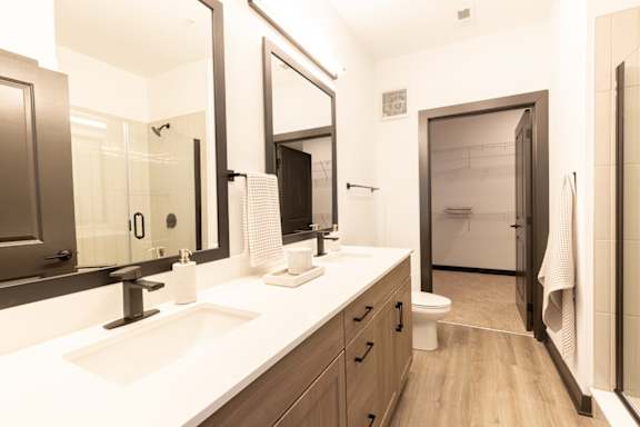a bathroom with two sinks and a toilet