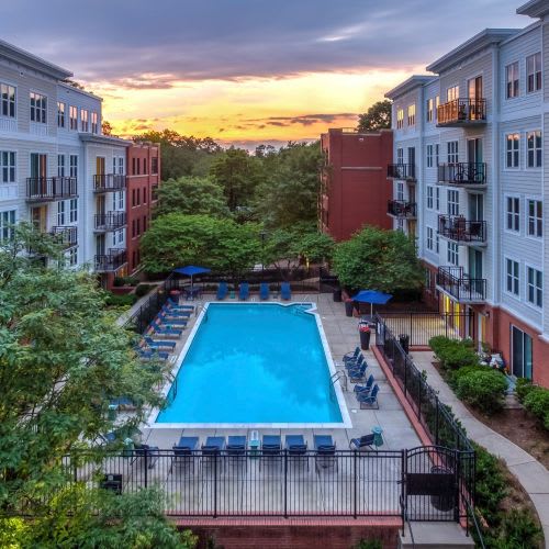 an aerial view of a swimming pool in the middle of an apartment building