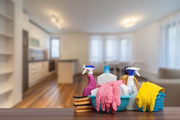 a basket of cleaning supplies on a table in a living room