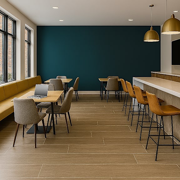 A room with a long table and chairs with a laptop on it.