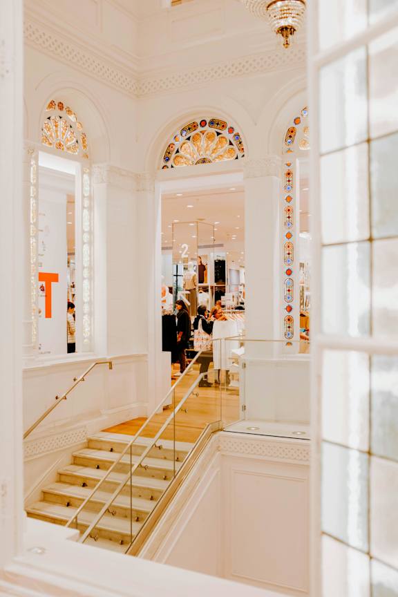 a view of a staircase in a museum with a glass door