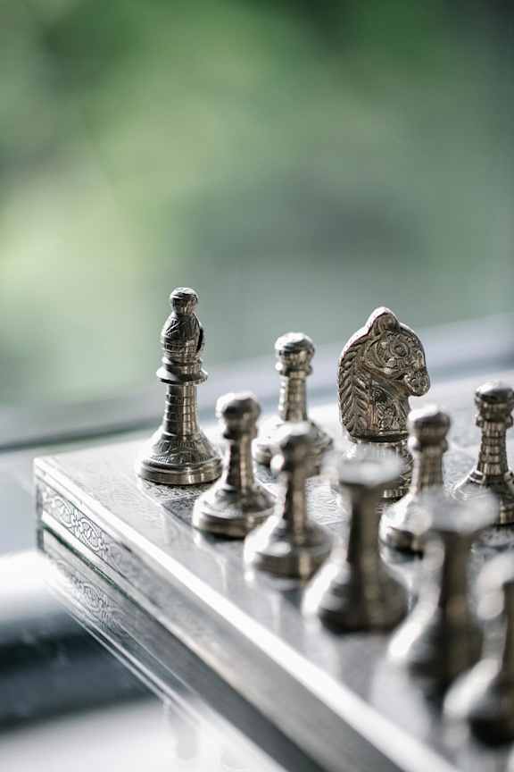 a chess board with chess pieces on a window