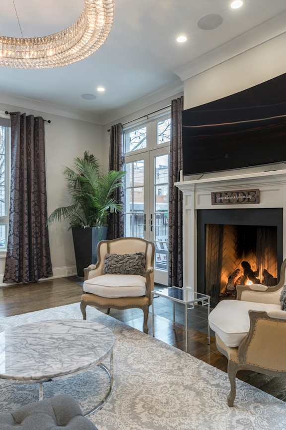 a living room with a fireplace and a television