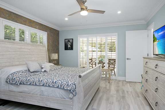 a bedroom with a bed and a ceiling fan