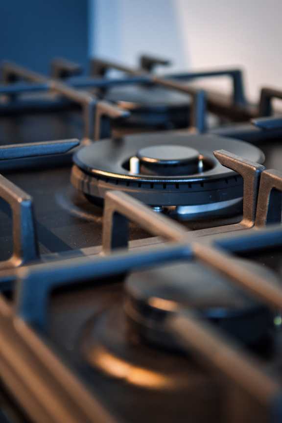 A close up of a gas stove with four burners.