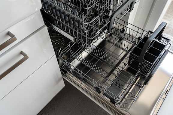A dishwasher with a full rack of dishes.