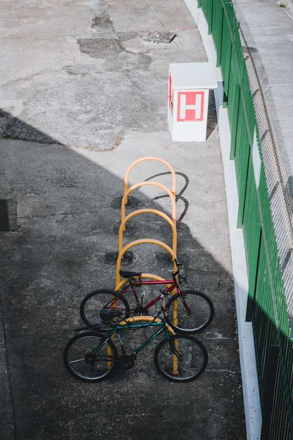 A bicycle is chained to a post.