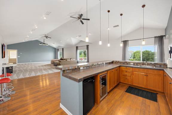 A modern kitchen with a large island and a dining area.