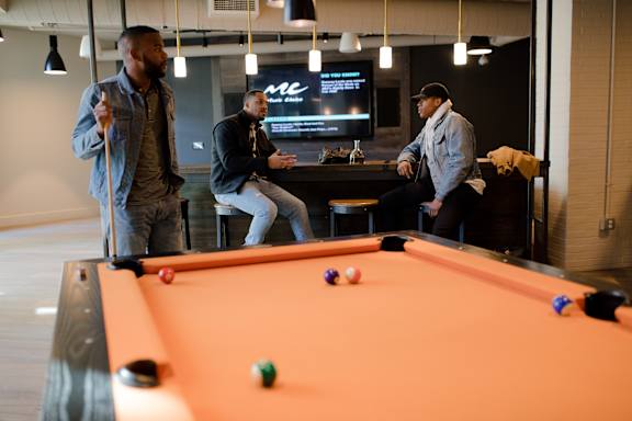 3 gentlemen enjoying Billiard and gaming lounge at Panda Properties