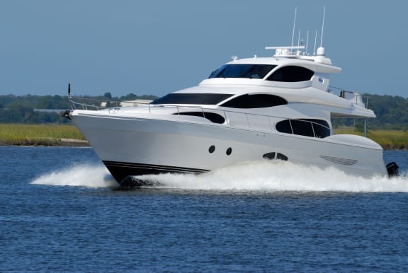 a white and black yacht speeding through the water