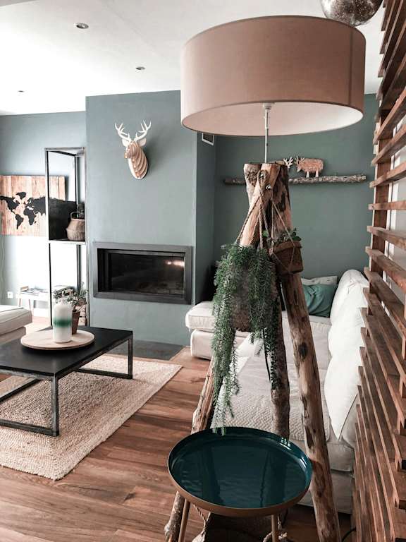 a living room with a couch and a table and a lamp