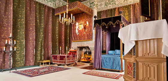a bedroom with a canopy bed and a fireplace