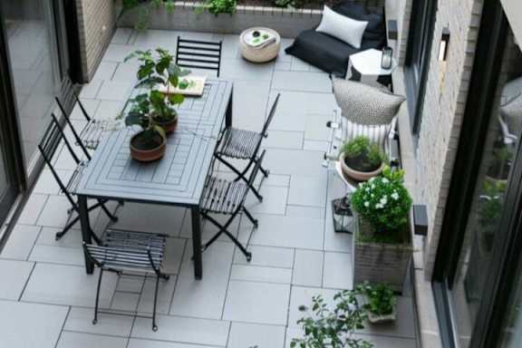 A patio with a table and chairs.