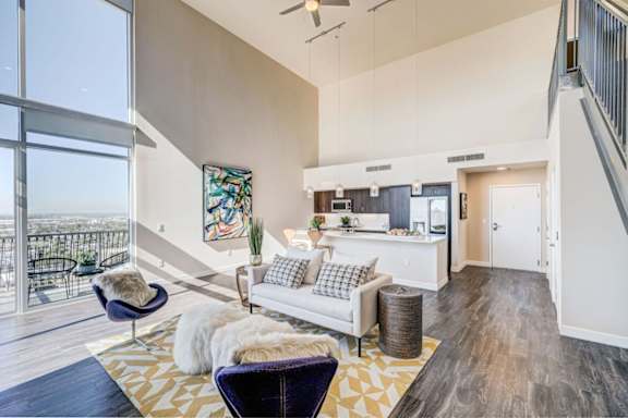 A living room with a white couch and a chair.