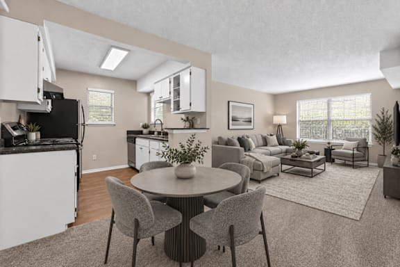 A modern kitchen with a dining table set for two.