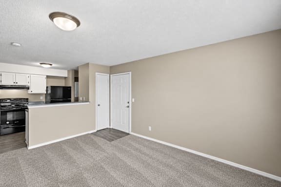 A kitchen area with a microwave, oven, and cabinets.