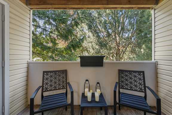 Two chairs and a table on a deck at Clackamas Trails Apartments, Oregon, 97222