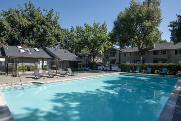 swimming pool with lounge chairs at Delta Pointe Apartments, California, 95833