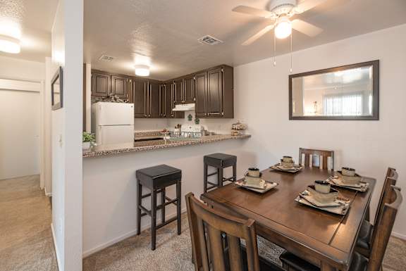 A kitchen with a table set for four at Sierra Glen Apartments, California, 95621