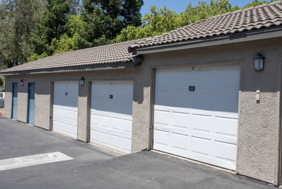 a row of garages with white garage doors