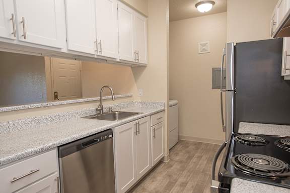 A kitchen with a stove, sink, and cabinets at Sunset Summit, Rocklin, CA, 95765