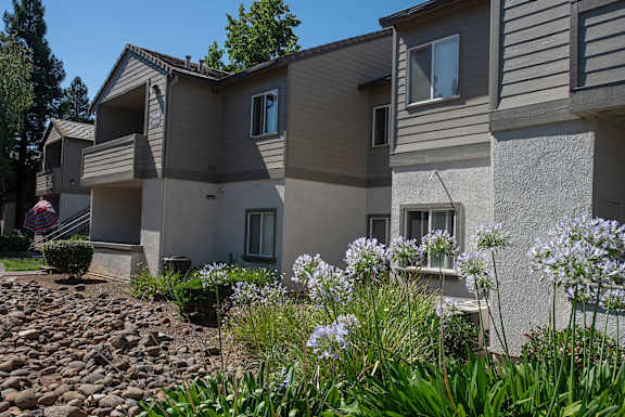A row of apartments with a garden in front at Sunset Summit, Rocklin, CA, 95765